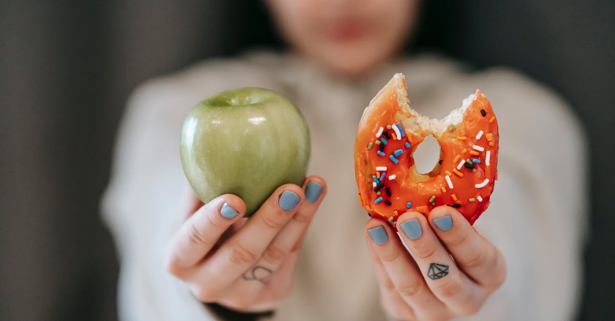 Convert weight of Confectioners sugar to caster sugar - Woman showing apple and bitten doughnut