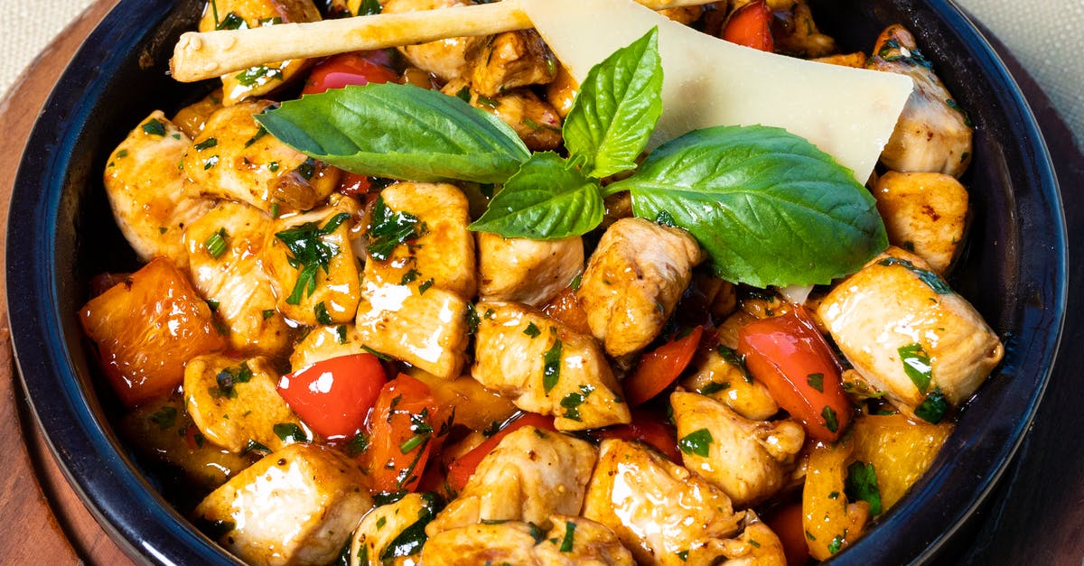 Cooking a chicken and vegetable curry using a curry paste - Cooked Food on Black Ceramic Bowl