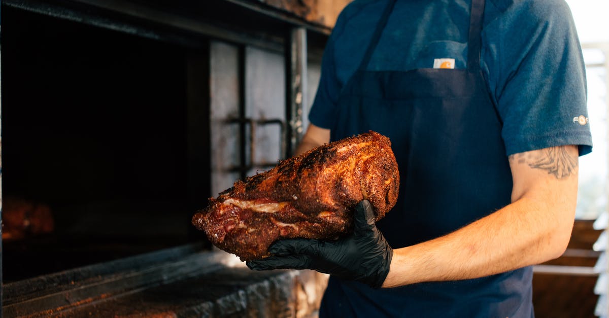 Cooking a large pork roast in a slow cooker - A Man Holding a Roasted Meat