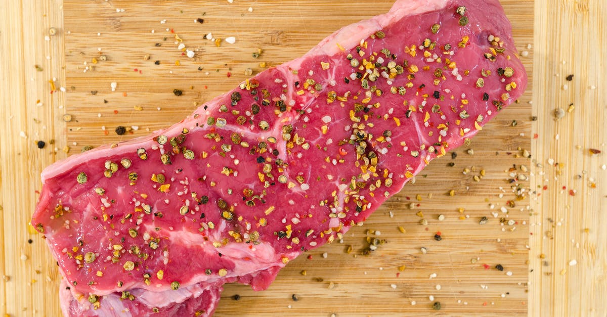 Cooking beef for pepper steak - Raw Meat on Beige Wooden Surface