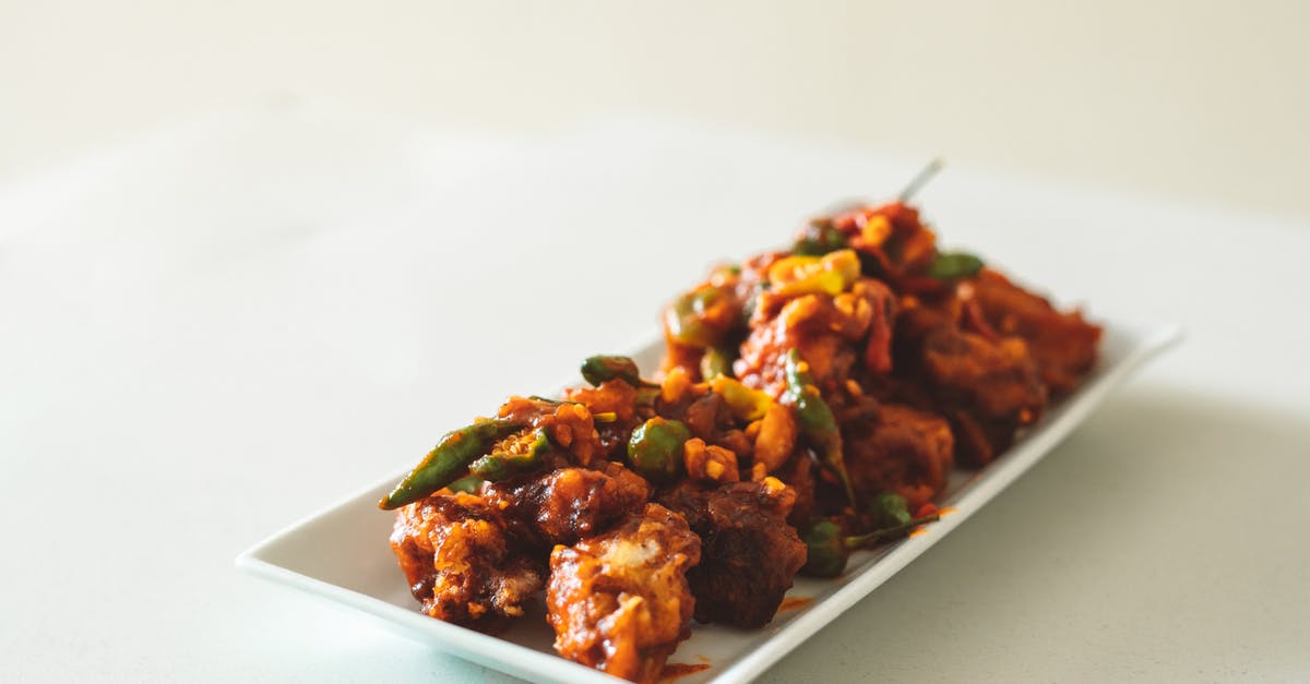 Cooking chicken breasts in Buffalo sauce, cast iron - Cooked Food on White Ceramic Plate