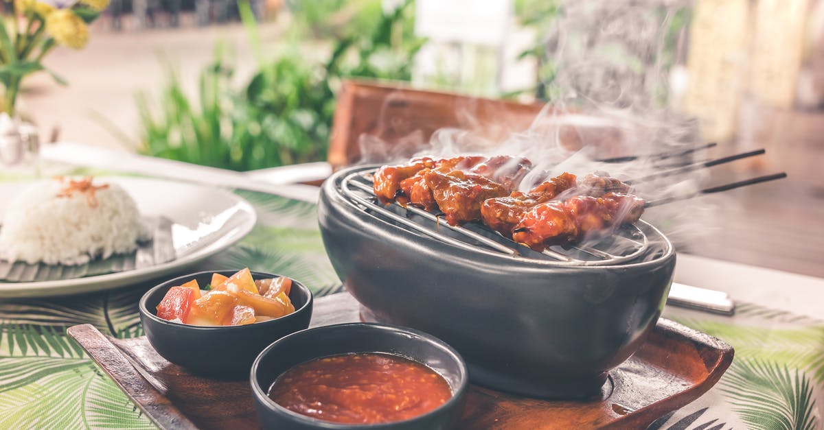 Cooking chicken breasts in Buffalo sauce, cast iron - Barbecue on Grill With Sauce Platter