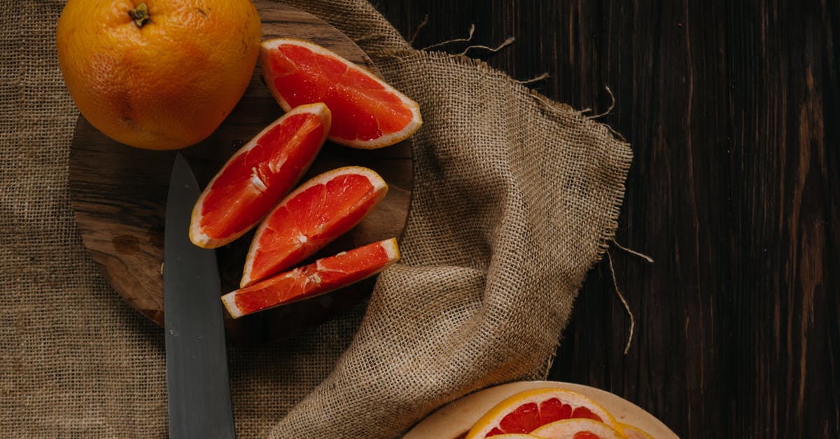 Cooking lemon juice into stew - Sliced Orange Fruit on Brown Textile