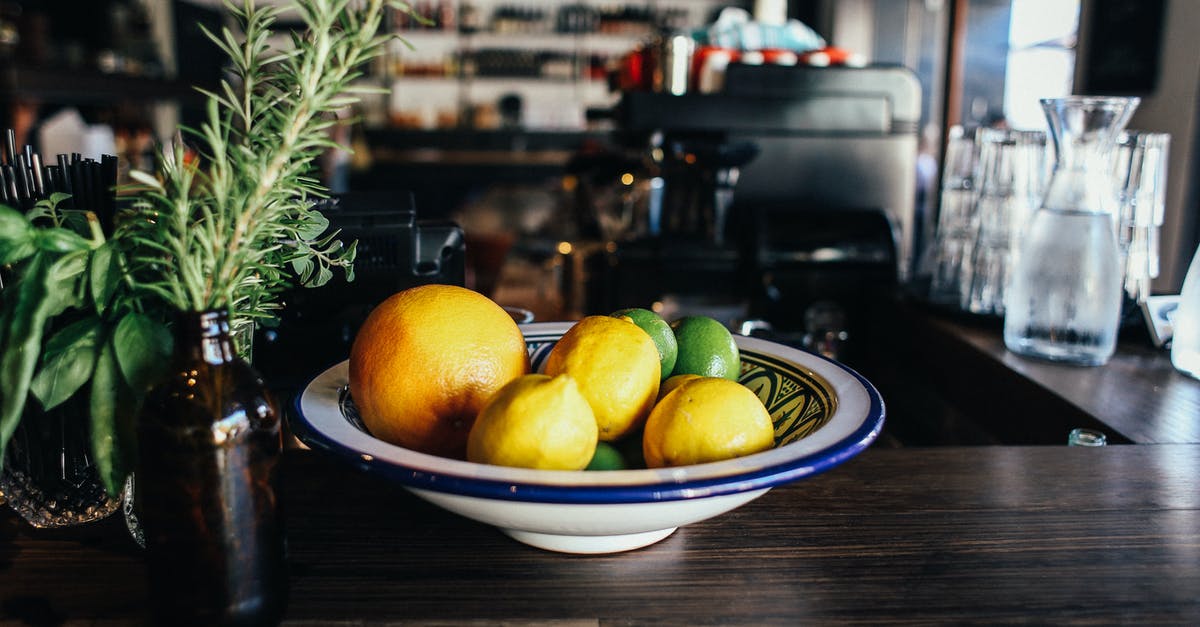 Cooking lemon juice into stew - Yellow Citrus Fruits on White and Blue Ceramic Plate