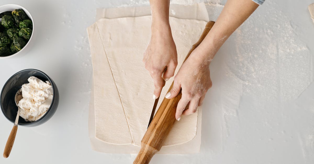 cooking pastry for bottom of pie using cold filling - Person Holding Brown Wooden Rolling Pin