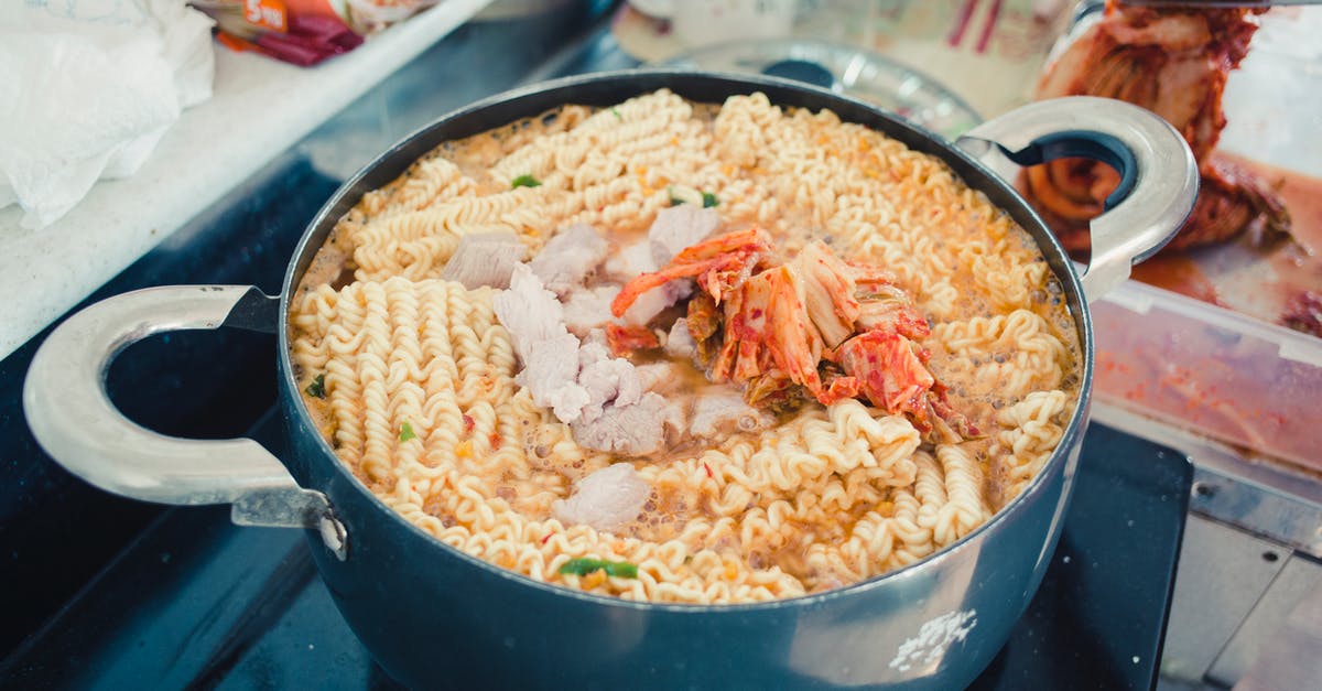 Cooking pot with regulable water boiling temperature - Close-Up Photo of a Pot with Noodles and Kimchi