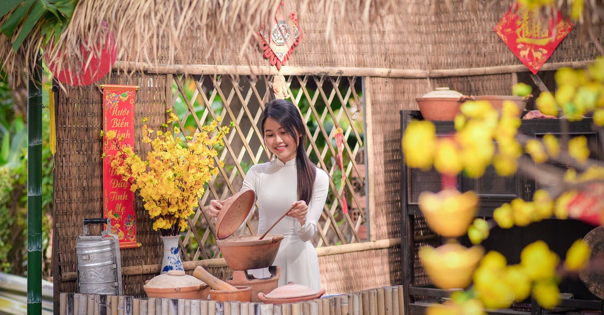 Cooking pots overheated - Woman in White Long Sleeve Shirt Sitting on Brown Wooden Chair