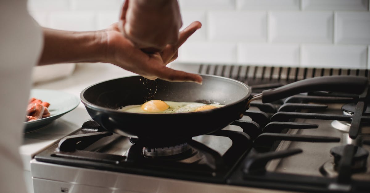 Cooking Scrambled Eggs ends up with excess liquid - Person Cooking on Black Frying Pan