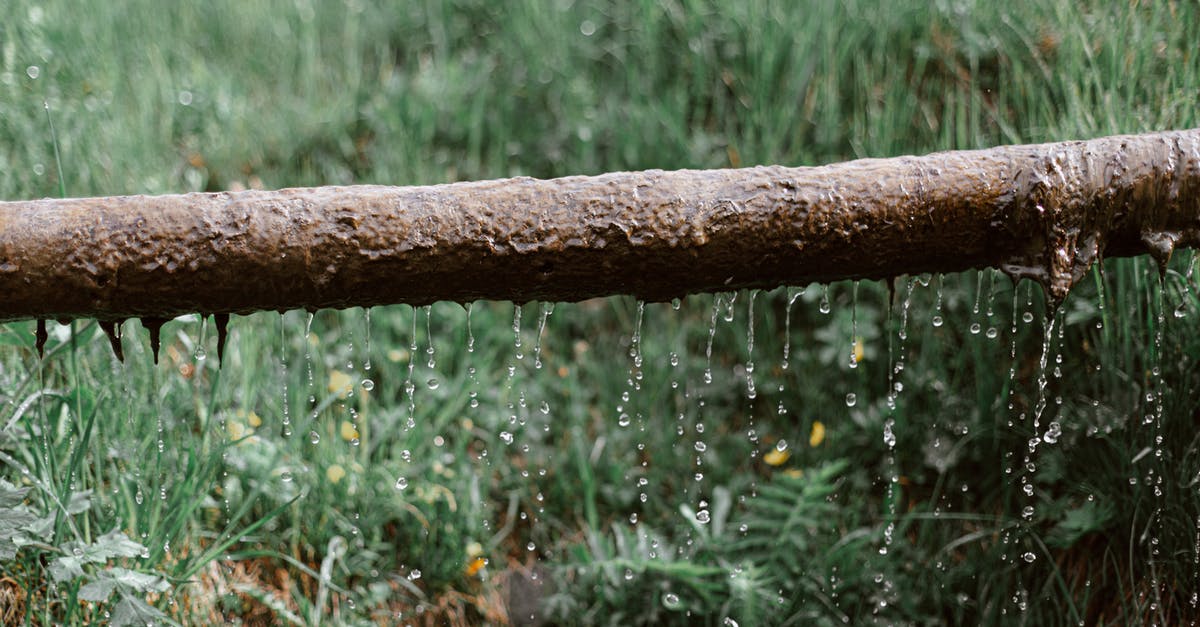 Cooking through thick liquids - Rusted metal leaking pipe above grassy meadow