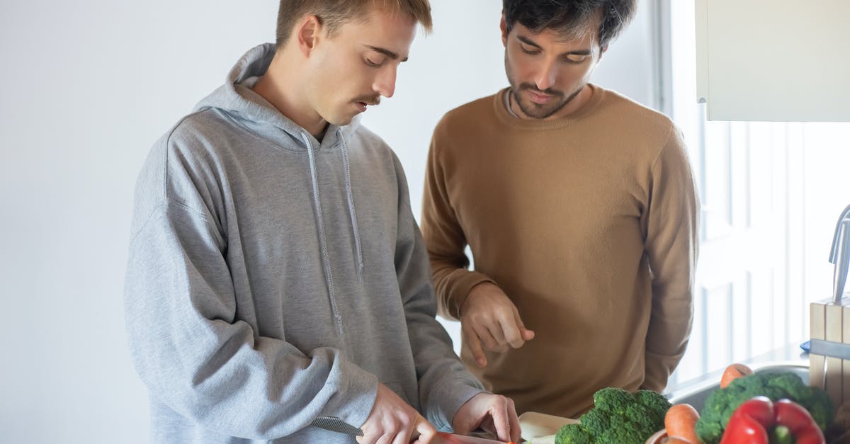 Cooking time for steaming vegetables "Al Dente'? - Man in Gray Sweater Slicing the Red Bell Pepper