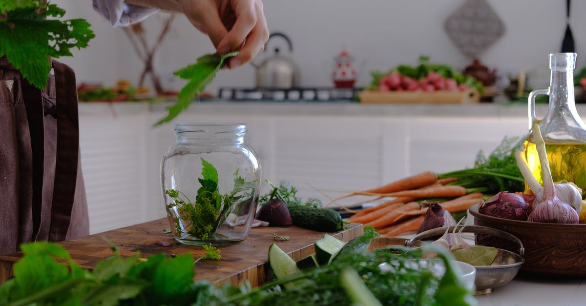 cooking vegetables for mashing - Person Putting Vegetable Leaves in Clear Glass Jar