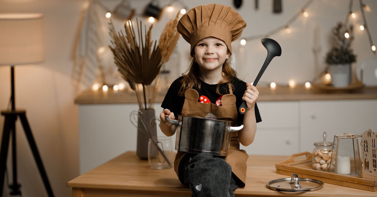 Cooking with a crock pot - temp - Little Girl Dressed as a Chef Sitting on a Kitchen Counter Holding a Pot and a Soup Spoon 