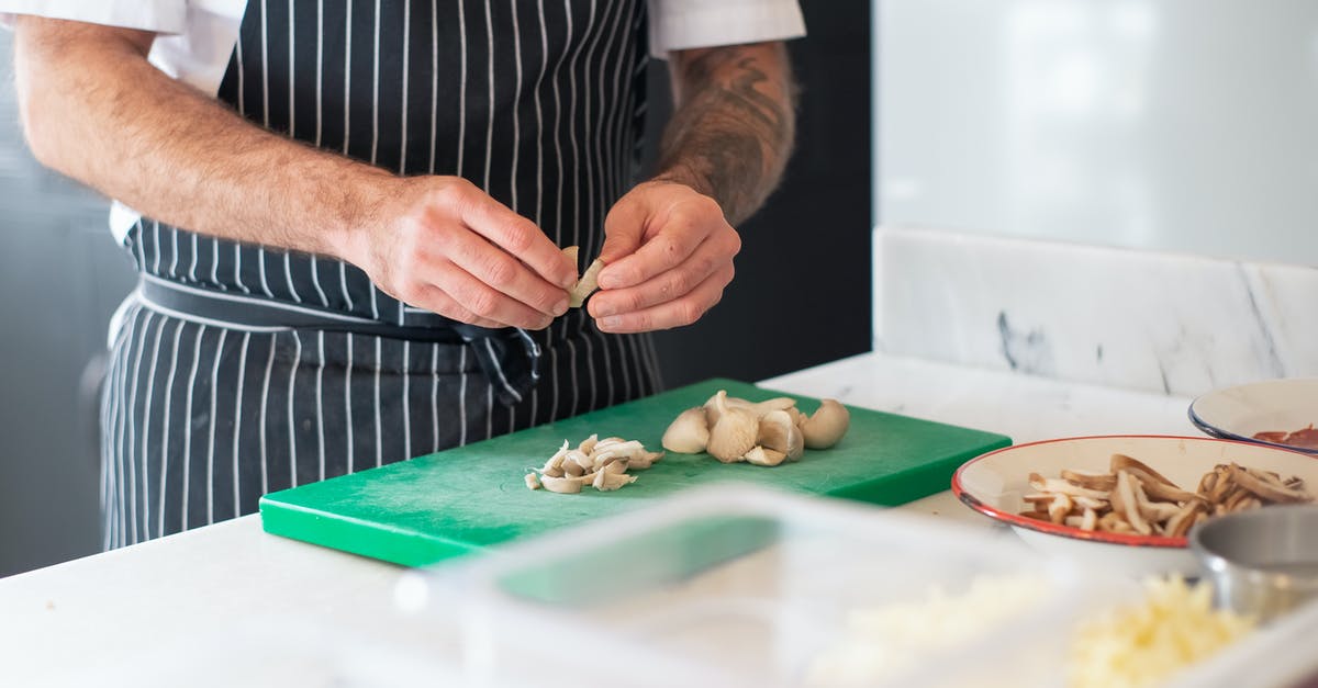 Cooking with a cut or burn on my hands - Man in Striped Apron Chopping Mushrooms on Green Chopping Board