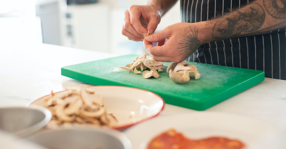 Cooking with a cut or burn on my hands - Man in Apron Peeling Mushrooms