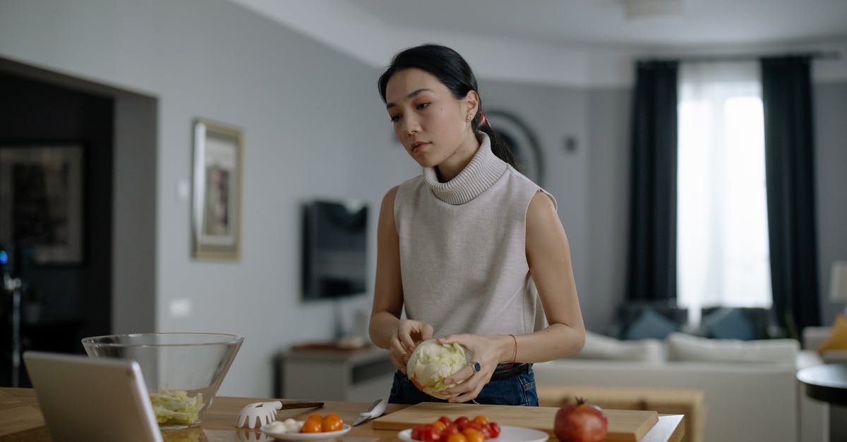 Cooking with Ornamental Cabbage (Kale)? - A Woman Preparing Food While Watching in an Ipad