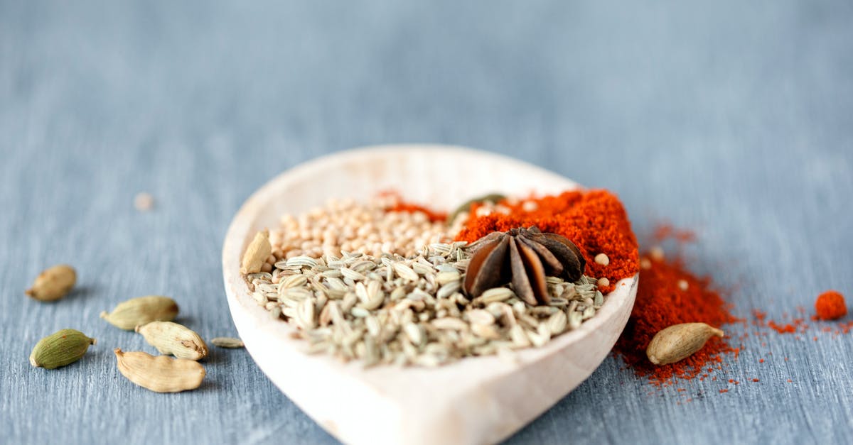 Cooking with papaya seeds - what does heating them do? - Assorted Seasoning in White Ceramic Spoon