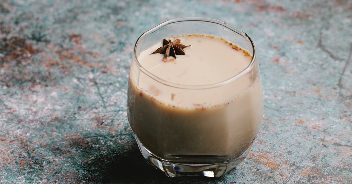 cooling pasturized milk - Glass of hot drink with anise