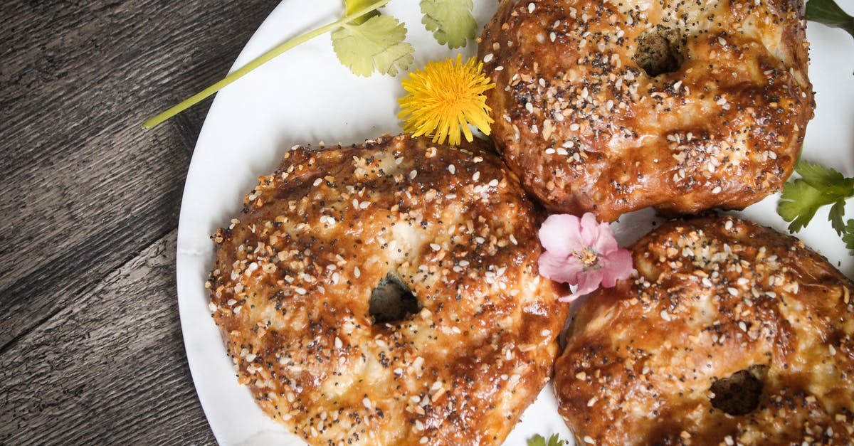 Coriander Seeds - Bagels in Plate with Flowers and Coriander Garnish