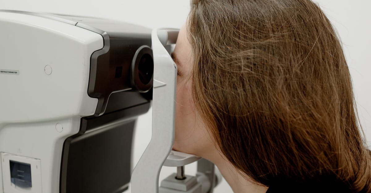 Correct procedure to thaw frozen pizza dough? - Woman checking eyesight on modern equipment