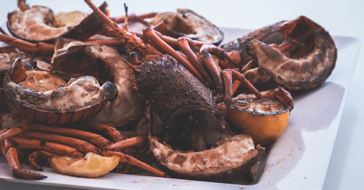 Could I possibly tell imitation lobster from real lobster? - Appetizing roasted lobsters served on plate in restaurant