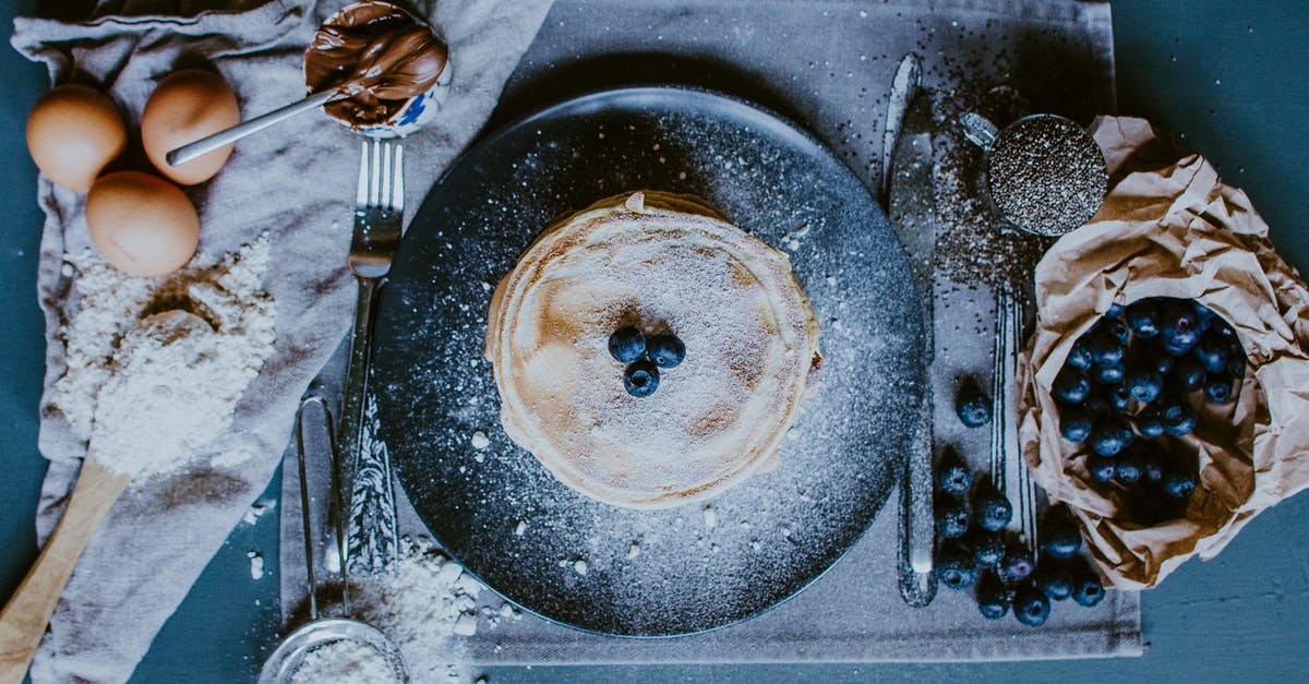 Crepe vs Pancake - Tasty crepes with blueberries and raw ingredients for recipe