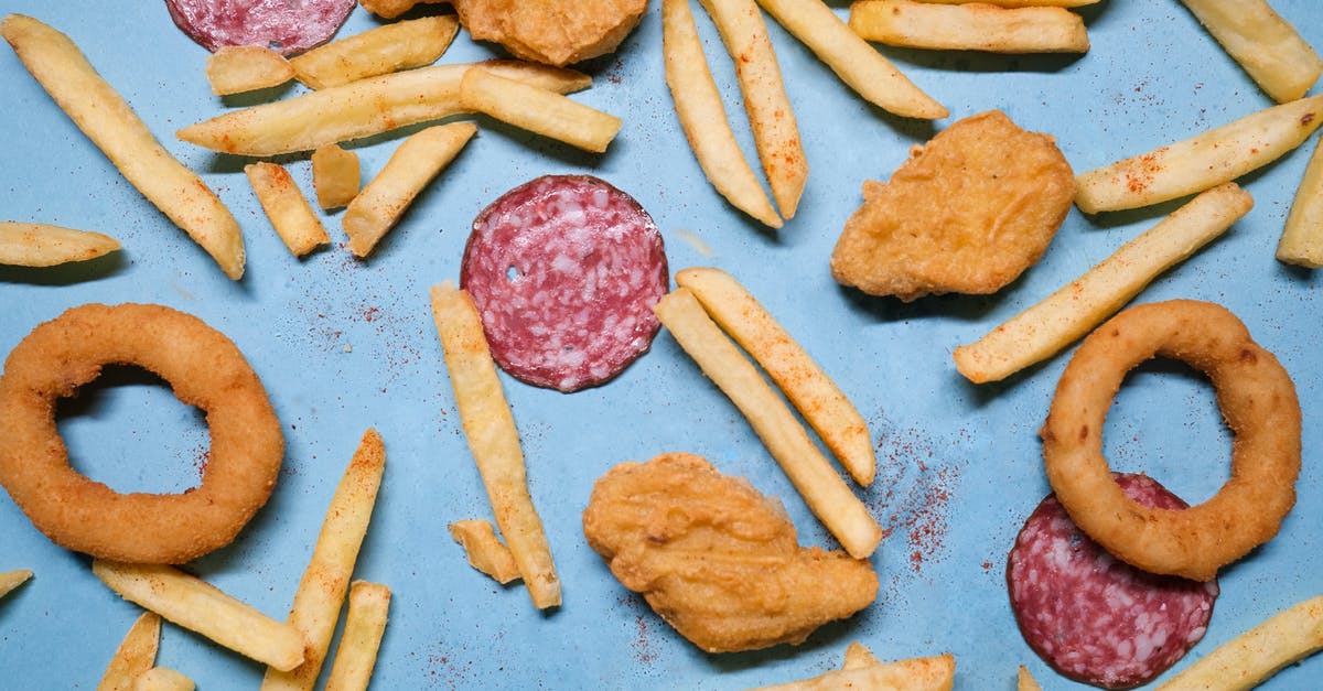 Crispy cold fried chicken - Salami with onion rings and nuggets near french fries