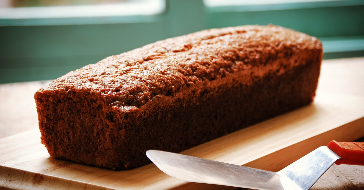 Crispy Lembas Bread Recipe - High angle of whole crispy fresh baked banana bread served on wooden cutting board and placed on table with spatula