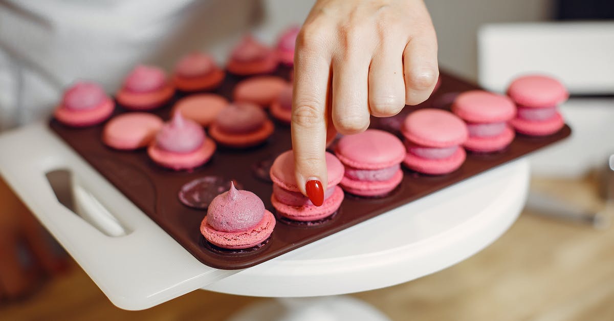 Crispy pork belly, how can I cook the inside more? - Woman placing shells of macaroons on top