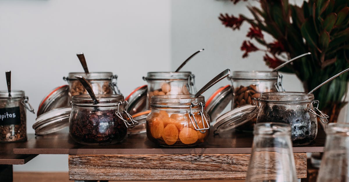 Crunchy vs Chewy dried apples? - Assorted dried fruits and nuts in transparent jars on table