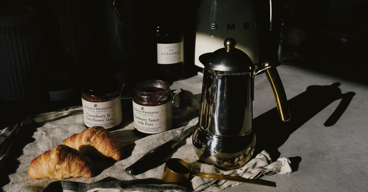 Crusty french bread - Delicious pair of fresh croissants with geyser coffee maker served for breakfast