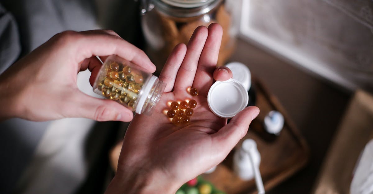 Cure #1 in Brine for Brisket - Person Holding Clear Glass Jar With White Round Medication Pill