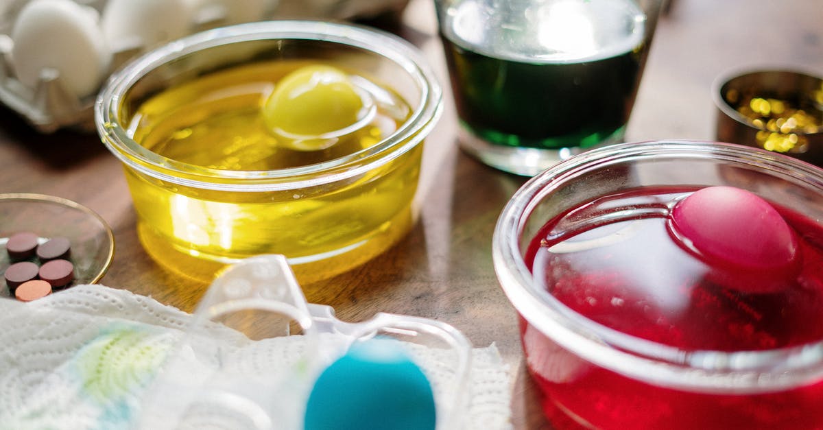 Cured Frozen Eggs - Eggs Dip in Clear Glass With Yellow Red and Green Liquid