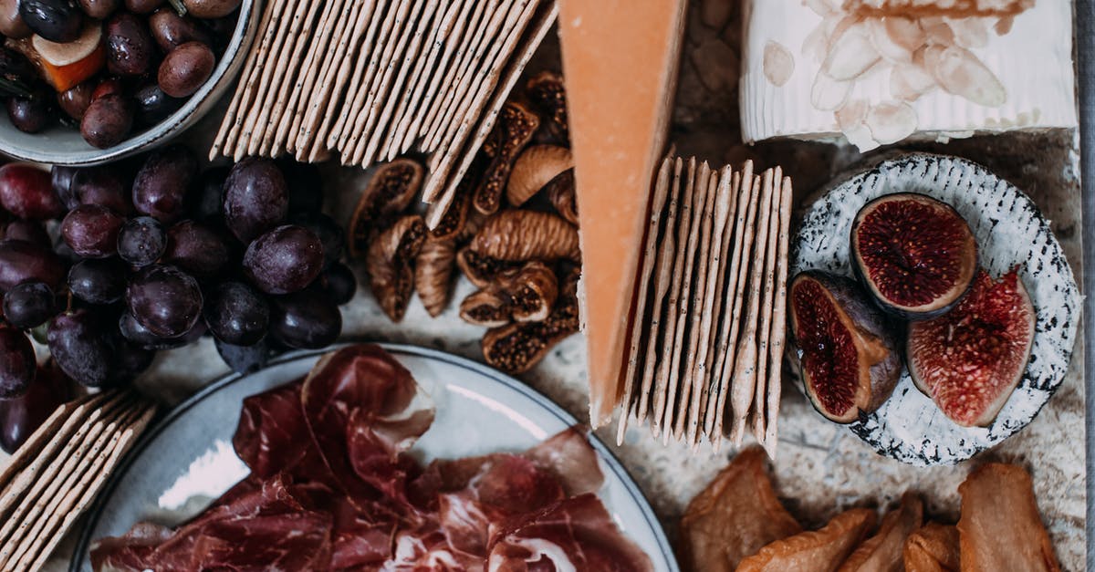 Curing fresh ham with limited ingredients - Top view of appetizing fresh fruits and meat on banquet table in cafe