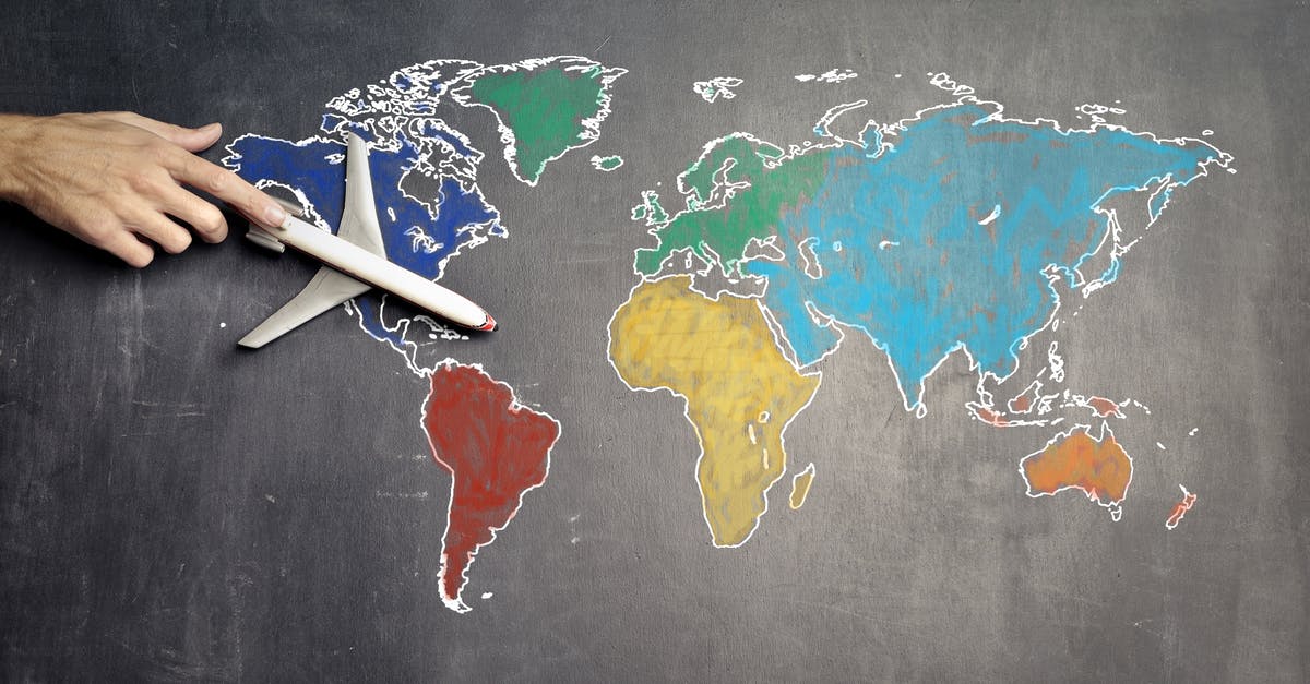 Curries from Scratch, a beginners guide [closed] - Top view of crop anonymous person holding toy airplane on colorful world map drawn on chalkboard