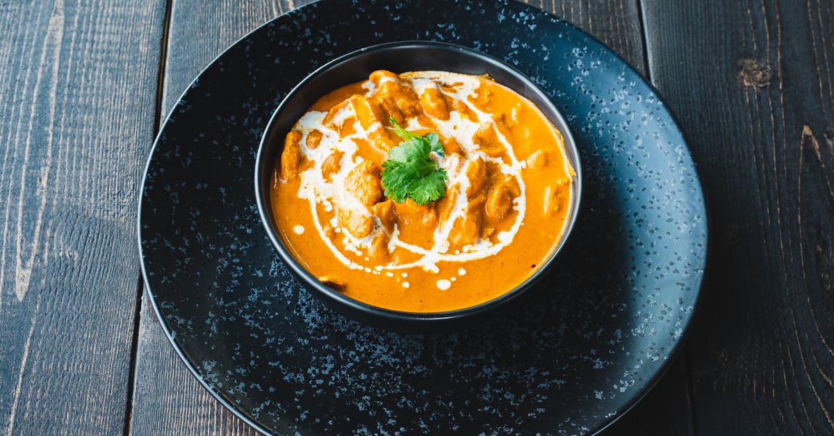 Curries with yoghurt-based marinade [duplicate] - Yellow Soup on Blue Ceramic Bowl