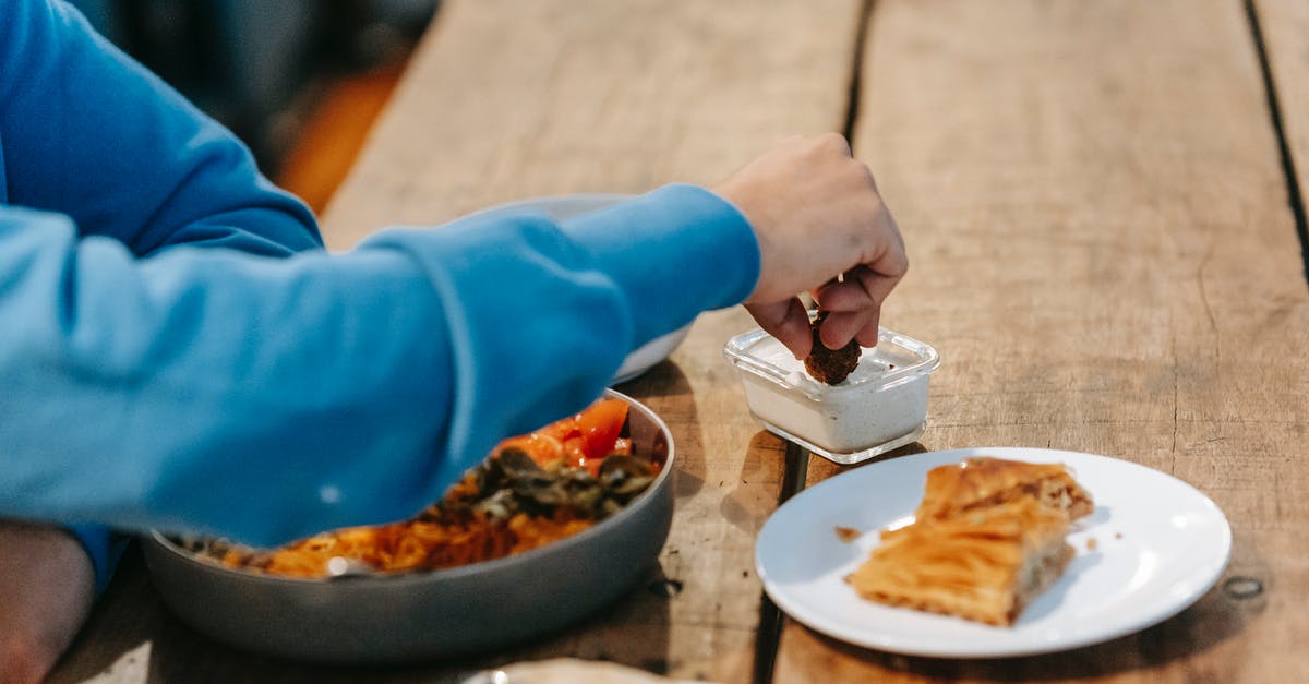 Cutting sugar in savory butternut squash dishes - Man having supper with tasty dish and baklava