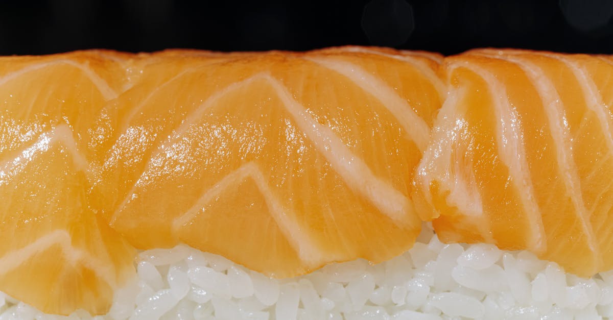 Cutting Sushi Rolls - White Rice on White Ceramic Plate