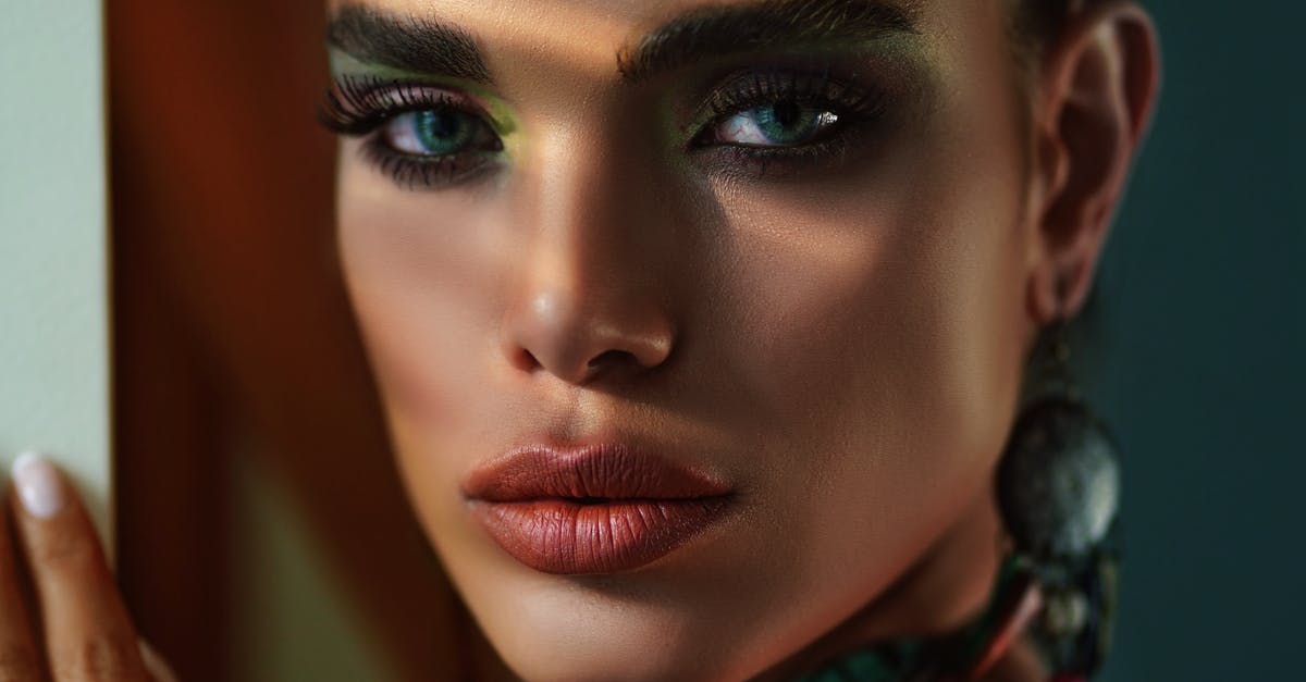 Deep frying and burning eyes - Crop stylish model with makeup near wall