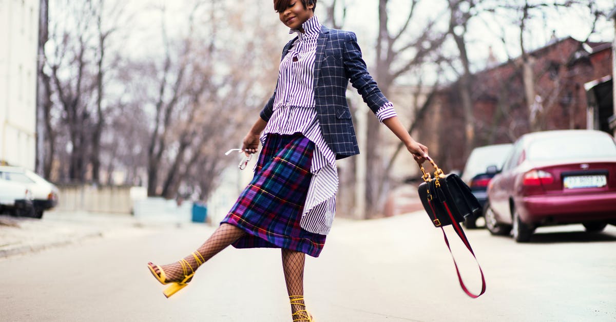 Defrosting Fish without Bag - Woman in Purple Top and Plaid Skirt Near Car