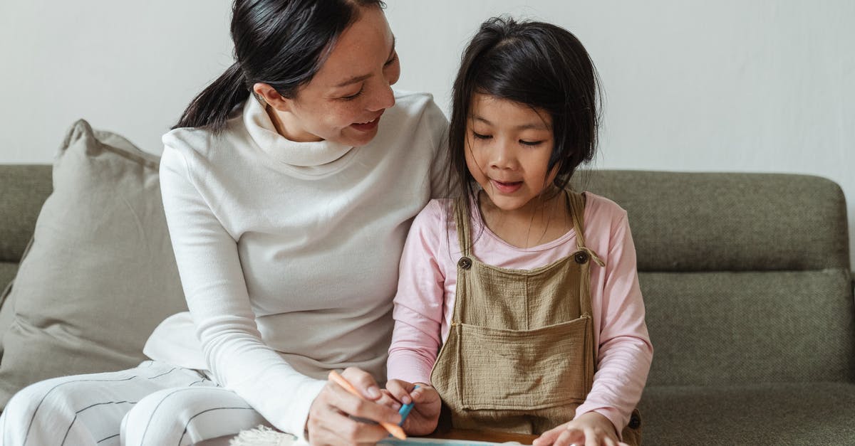 Dehydrating Strawberries - Wax Paper or Parchment? - Smiling woman tutoring ethnic girl at home