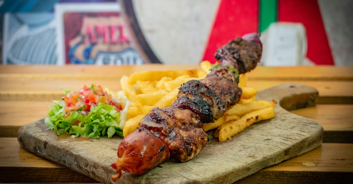 Dehydrator potato chips - Grilled Meat on Stick and Chips on Wooden Chopping Board