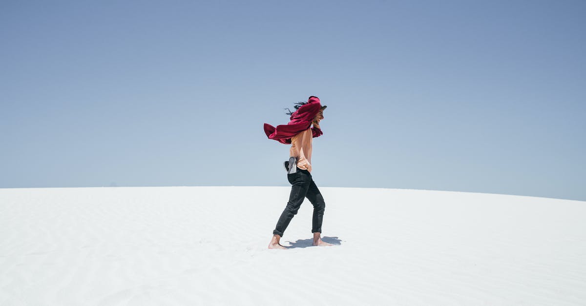 dehydrator temperatures - Woman in Red Jacket and Black Pants Walking on White Sand