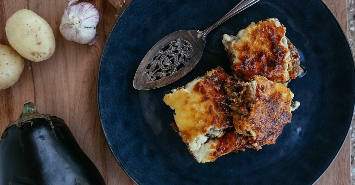 De-meatifying lasagna, casseroles - Stainless Steel Spoon on Blue Ceramic Plate with Vegetarian Eggplant Lasagna