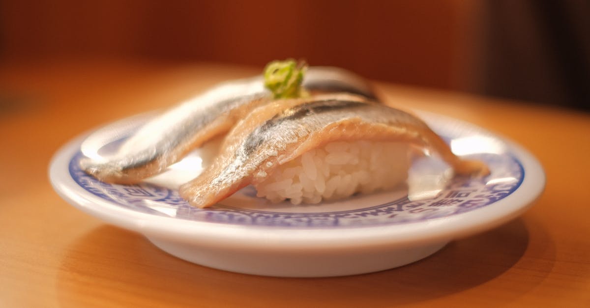 de-parasiting mackerel for sushi - Raw Fish with Sushi Rice on a Plate