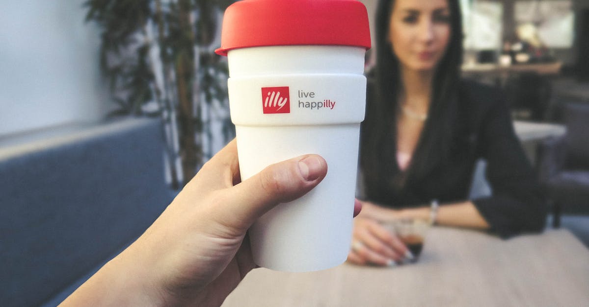 Describing the taste of Illy coffee and similar brands - Person Holding White and Red Live Happilly Cup