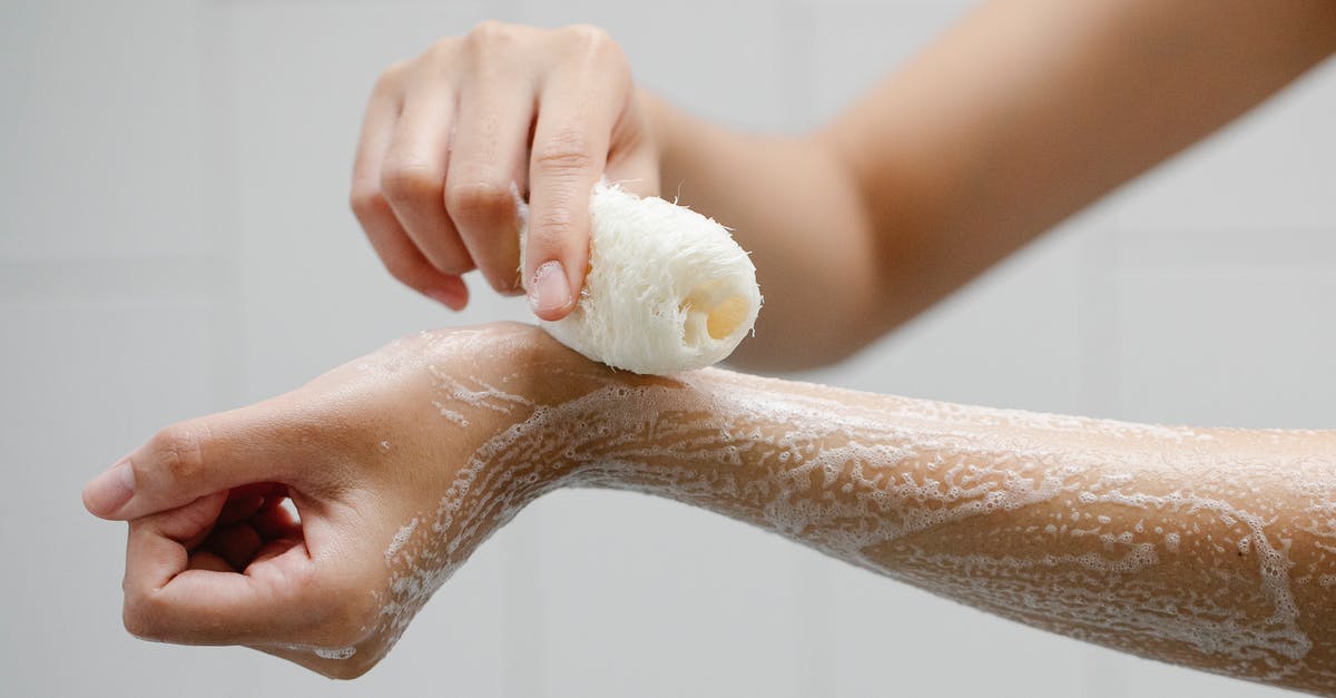 Detergent Contamination of Processed Foods - Crop anonymous person using wisp washing arms with soap foam during hygienic procedure