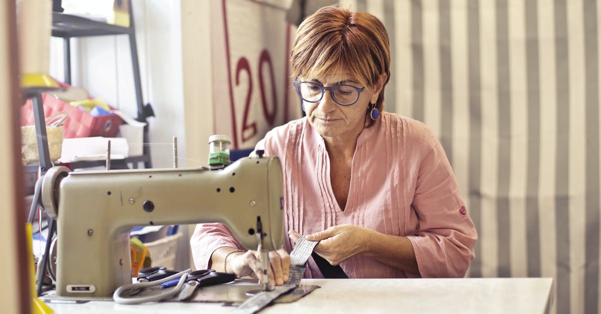 Determining a wok's material - Photo of Woman Using Sewing Machine