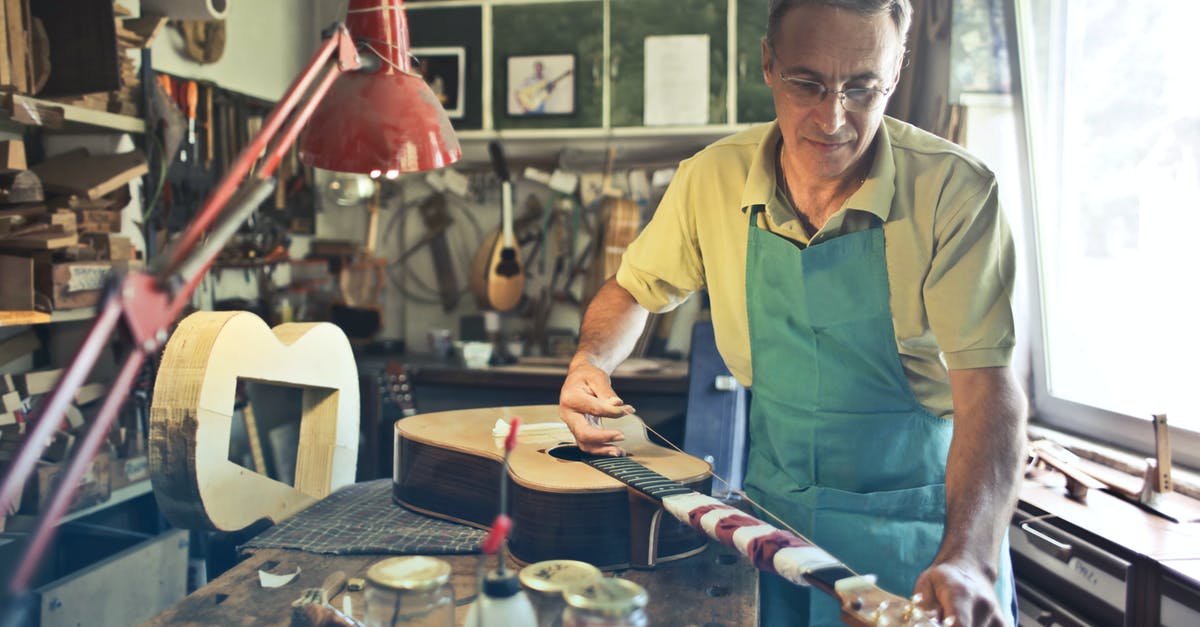 Determining a wok's material - Photo of Man Making an Acoustic Guitar