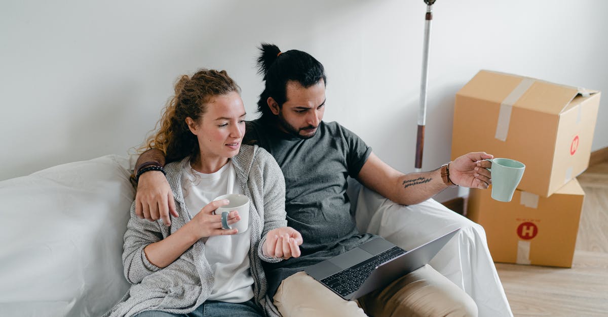 Device to squeeze last yogurt out of carton - Bonding couple browsing laptop after packing carton boxes