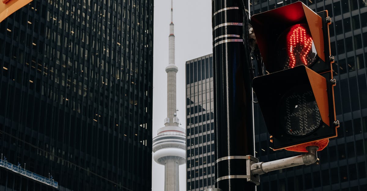 Difference between burritos, chimichanga, and enchiladas? - Traffic light with red color and TV tower between skyscrapers